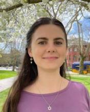 Person with long hair in purple shirt