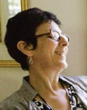 Head shot of person with glasses smiling