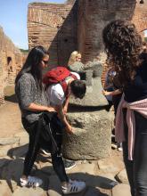 students explore a an ancient bakery in Pompeii