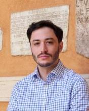 Person in front of wall with inscriptions set into it