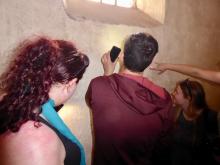 students reading graffiti at Pompeii