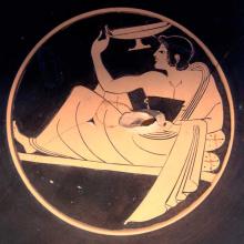 Detail of a Greek vase painting depicting a man eating while reclining