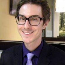 Person smiling in front of a window