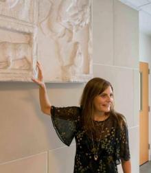 Person pointing to a sculpted relief in a museum