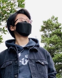 An image of Suh Young. She is wearing a dark grey hoodie and black mask.