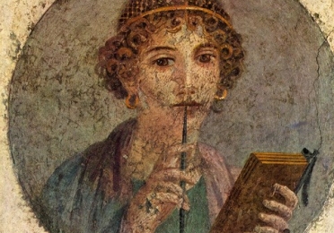 Painting of ancient person with book and pen
