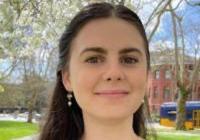 Person with long hair in purple shirt