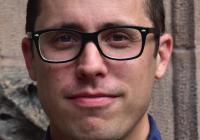 head shot of person with short hair and glasses