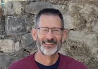 Person in front of stone wall