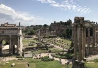 Monuments made out of marble, with columnar facades, dot a flat green landscape