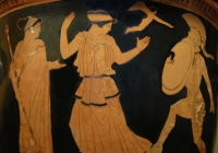 red figures on black background. Helen with raised arms at center, Menelaus cowers behind his shield to the right