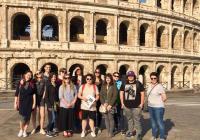 Students pose in front of the Roman colosseum