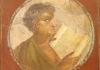 ancient fresco of young man reading