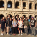 Students pose in front of the Roman colosseum