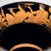 Red figure cup showing woman and man reclining at a symposium on the ground